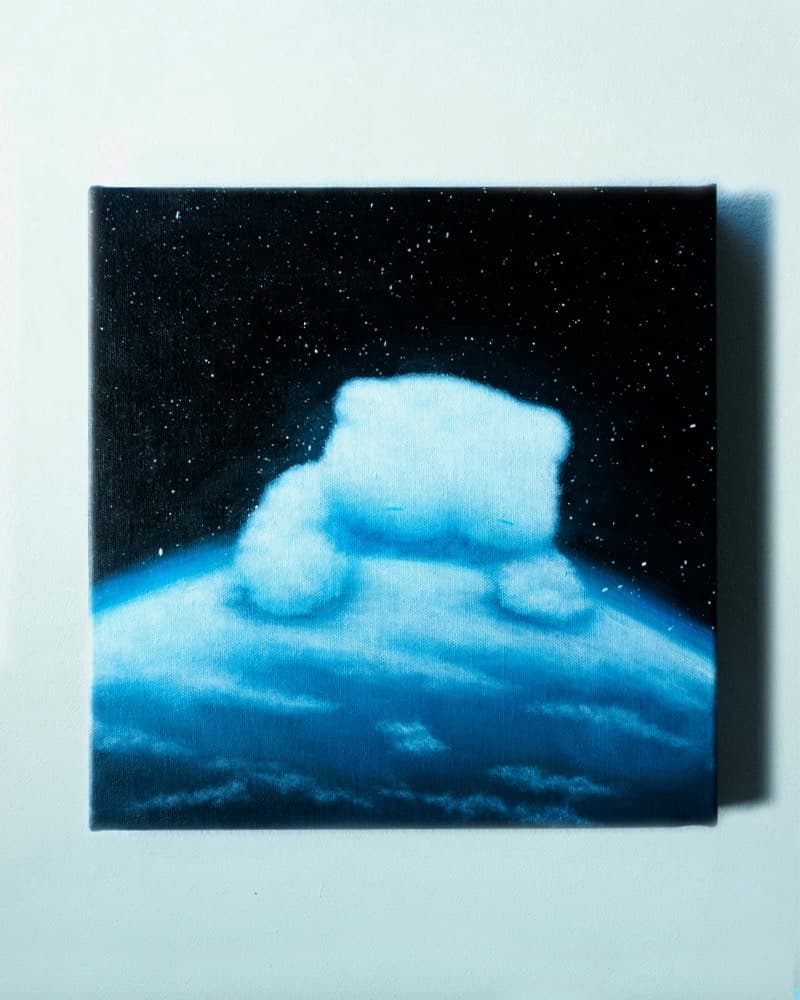 One large cloud-shaped cat cresting over the curved Earth, starfield behind